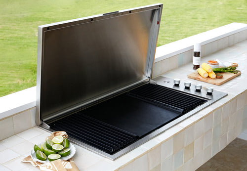An outdoor BBQ alfresco area with a square tiled bench top