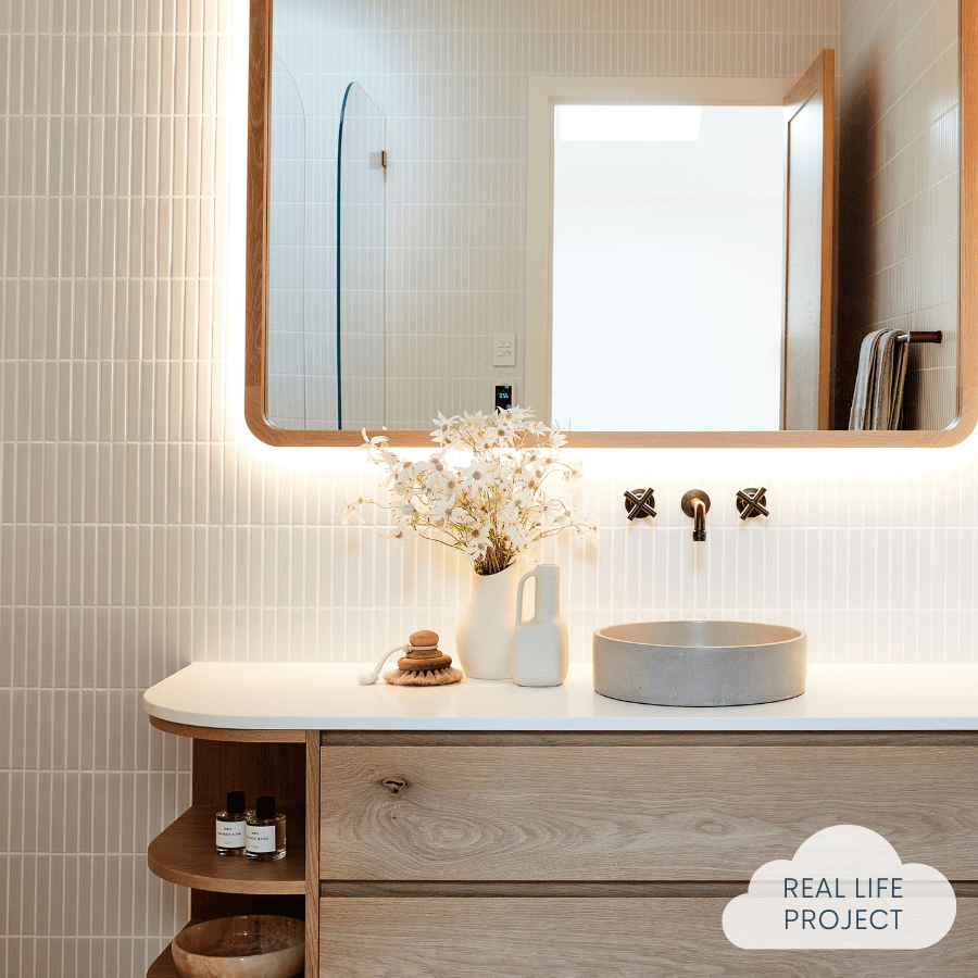 bathroom featuring white kit kat wall tiles, basin and mirror